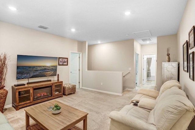 living room with recessed lighting, visible vents, light colored carpet, and baseboards