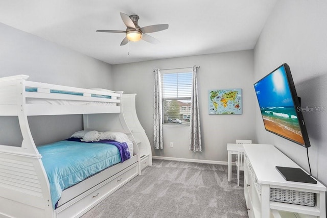 carpeted bedroom featuring ceiling fan and baseboards