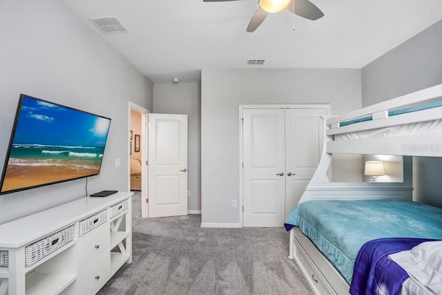 bedroom with carpet, visible vents, baseboards, ceiling fan, and a closet