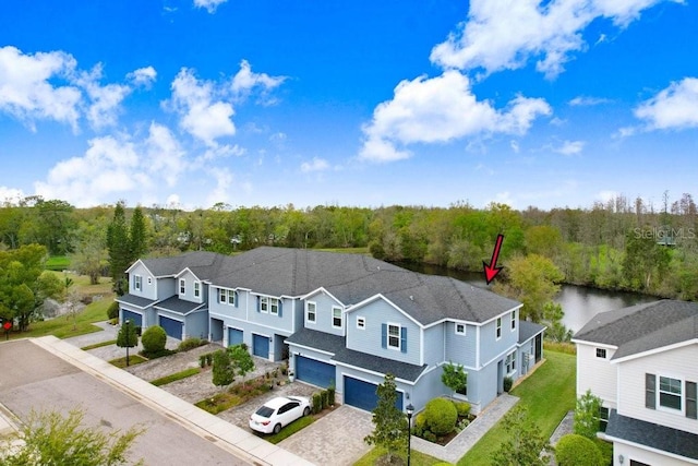 birds eye view of property with a view of trees