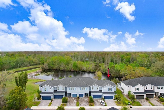 drone / aerial view with a view of trees and a water view