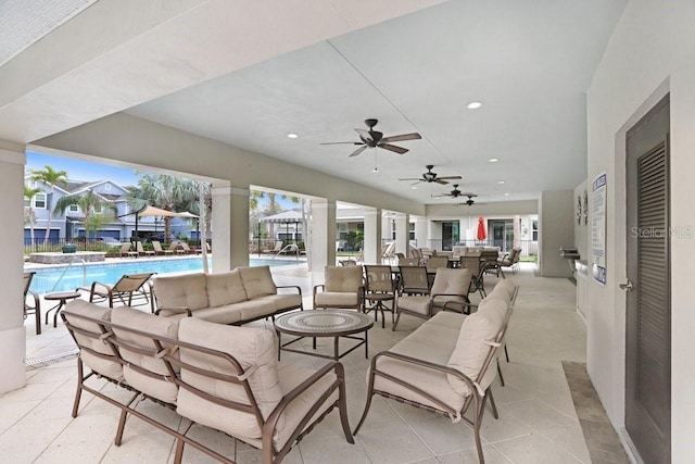 view of patio / terrace featuring an outdoor living space, a community pool, and ceiling fan