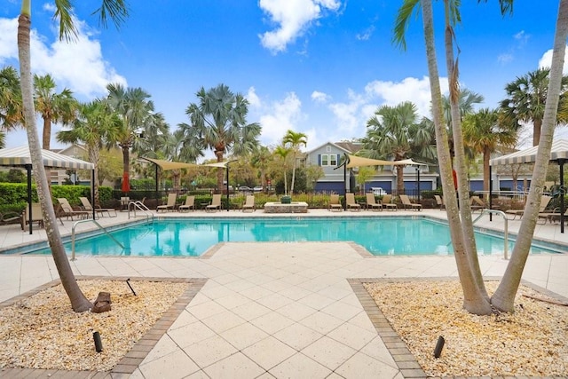 community pool featuring a patio and fence