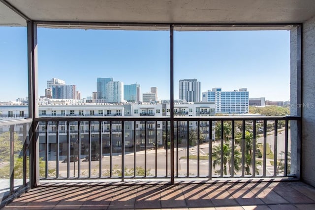 unfurnished sunroom featuring a view of city