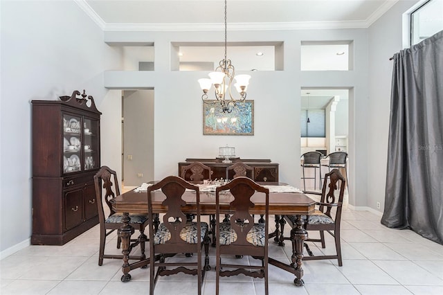 dining space with light tile patterned floors, an inviting chandelier, and crown molding