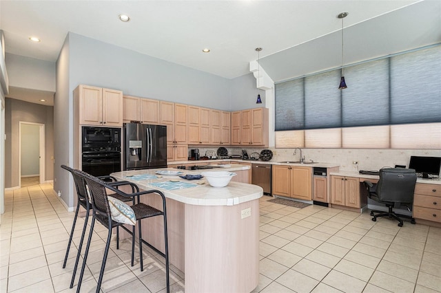 kitchen with black appliances, a center island, light brown cabinets, and a sink