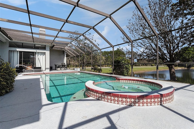 view of swimming pool with a patio area, glass enclosure, a pool with connected hot tub, and a water view