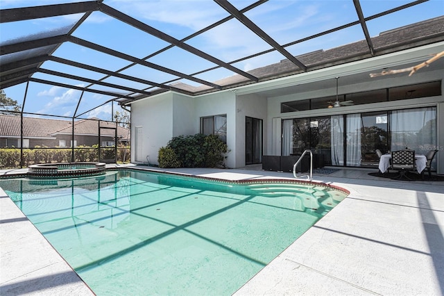 view of pool with a pool with connected hot tub, a lanai, a ceiling fan, and a patio area