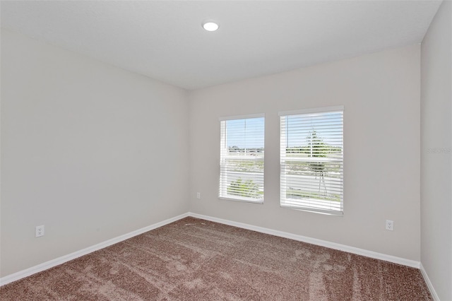 spare room featuring recessed lighting, baseboards, and carpet flooring