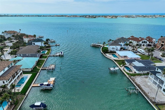 drone / aerial view featuring a residential view and a water view