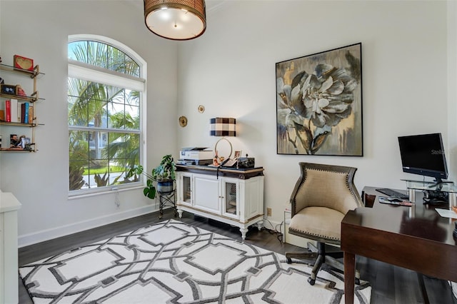 office featuring dark wood-type flooring and baseboards