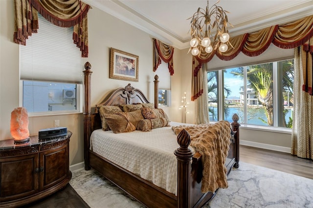 bedroom with an inviting chandelier, wood finished floors, baseboards, and ornamental molding