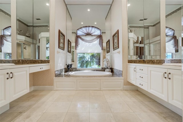 bathroom featuring tile patterned floors, a garden tub, two vanities, wallpapered walls, and walk in shower