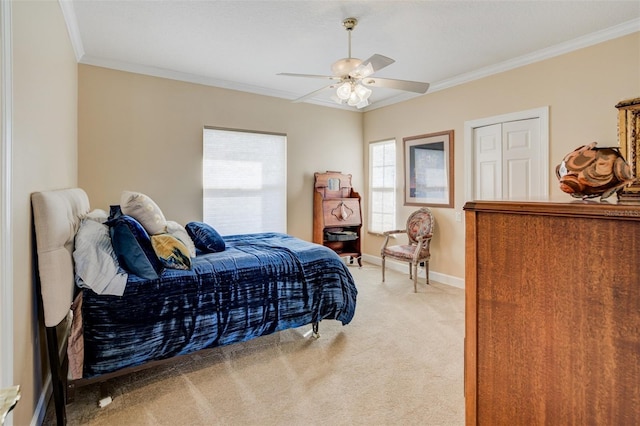 bedroom featuring ornamental molding, a ceiling fan, baseboards, and light carpet