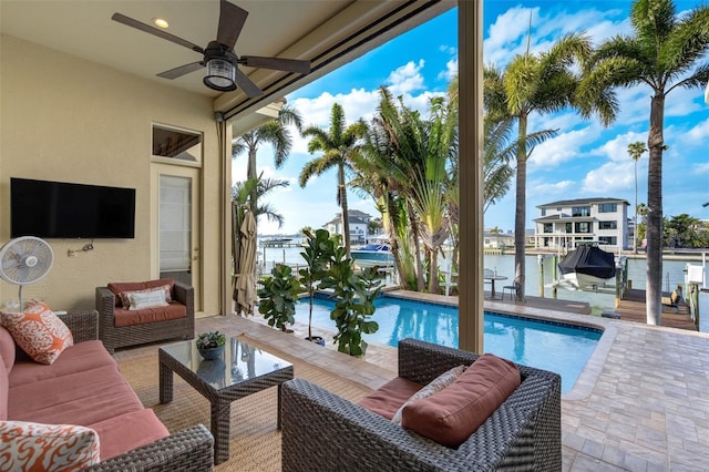 outdoor pool featuring a water view, outdoor lounge area, a boat dock, boat lift, and a ceiling fan