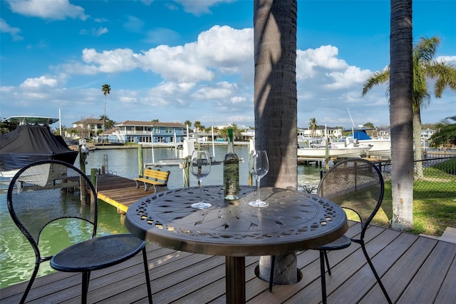 dock area with boat lift and a water view