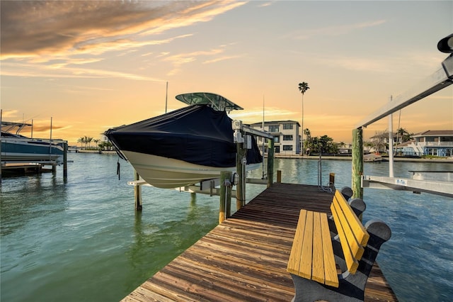 view of dock featuring boat lift and a water view