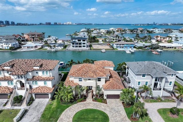 drone / aerial view with a residential view and a water view