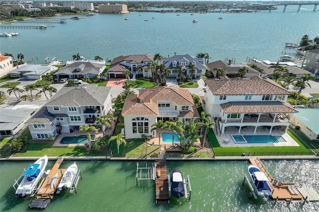 drone / aerial view with a residential view and a water view