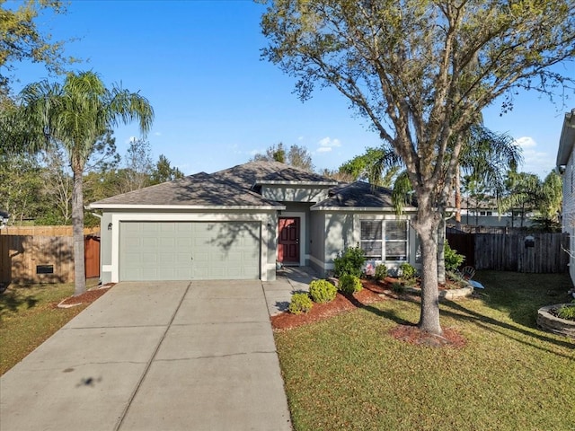 view of front of house with stucco siding, a garage, and fence