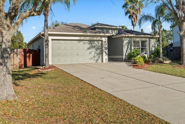 view of front of home with a front yard, fence, stucco siding, concrete driveway, and a garage