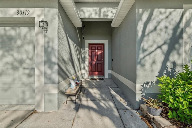 view of exterior entry with stucco siding