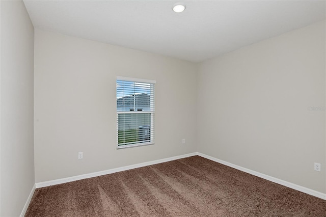 empty room with carpet flooring and baseboards