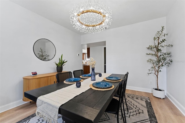 15703 Jericho Dr, Odessa, FL 33556 - dining space with light wood-type flooring, baseboards, and a chandelier