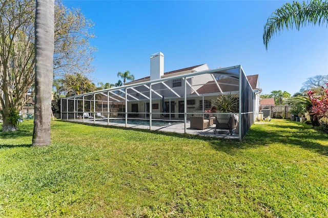 15703 Jericho Dr, Odessa, FL 33556 - back of property with a patio, a lawn, a chimney, an outdoor pool, and glass enclosure