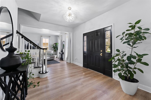 15703 Jericho Dr, Odessa, FL 33556 - entrance foyer with stairs, wood finished floors, baseboards, and a chandelier