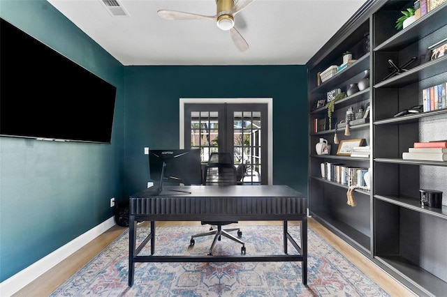 15703 Jericho Dr, Odessa, FL 33556 - office area featuring wood finished floors, a ceiling fan, baseboards, and built in shelves