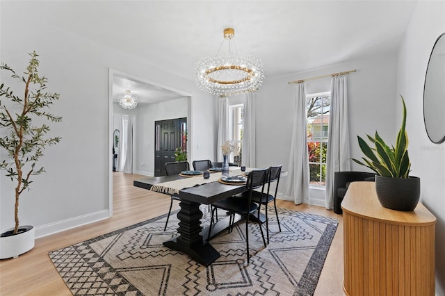 15703 Jericho Dr, Odessa, FL 33556 - dining space featuring a chandelier, light wood-type flooring, and baseboards