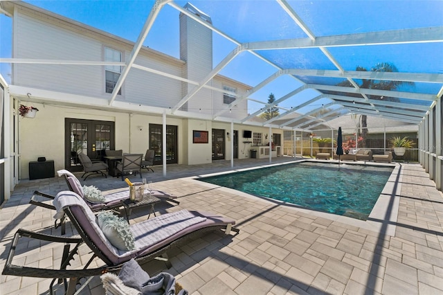 15703 Jericho Dr, Odessa, FL 33556 - outdoor pool with french doors, a patio, and glass enclosure