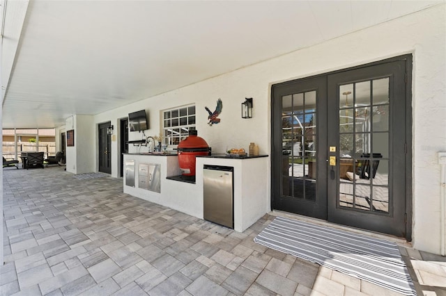 15703 Jericho Dr, Odessa, FL 33556 - view of exterior entry featuring exterior kitchen, french doors, a patio, and stucco siding