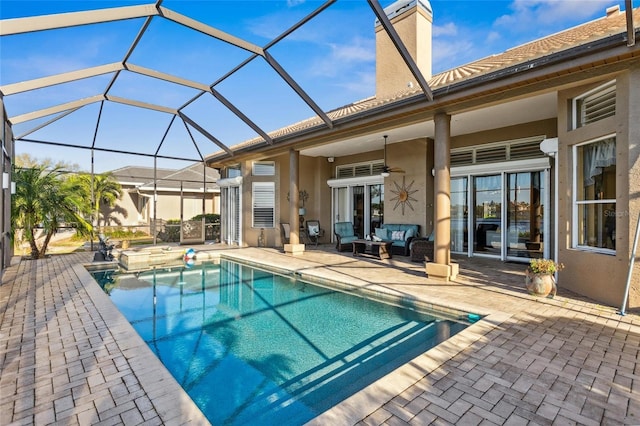 pool with a patio, an in ground hot tub, ceiling fan, a lanai, and an outdoor hangout area