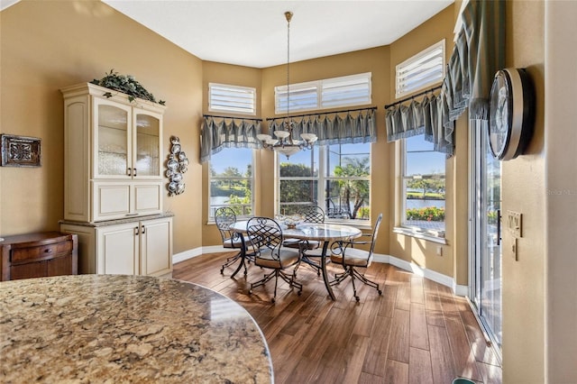 dining room with dark wood-style floors and baseboards