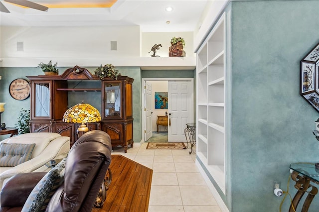 living area featuring ceiling fan, visible vents, and light tile patterned flooring