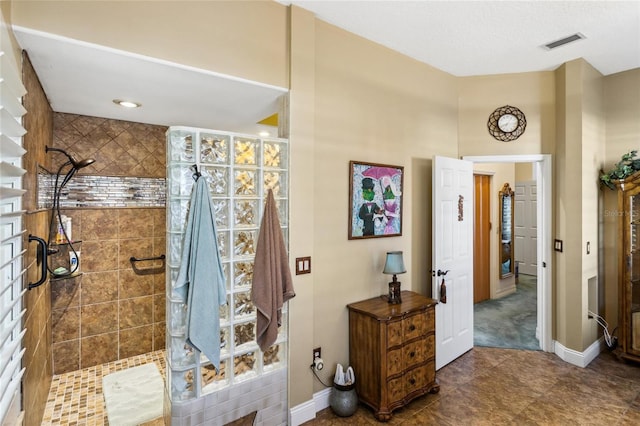 full bathroom featuring baseboards, visible vents, and walk in shower