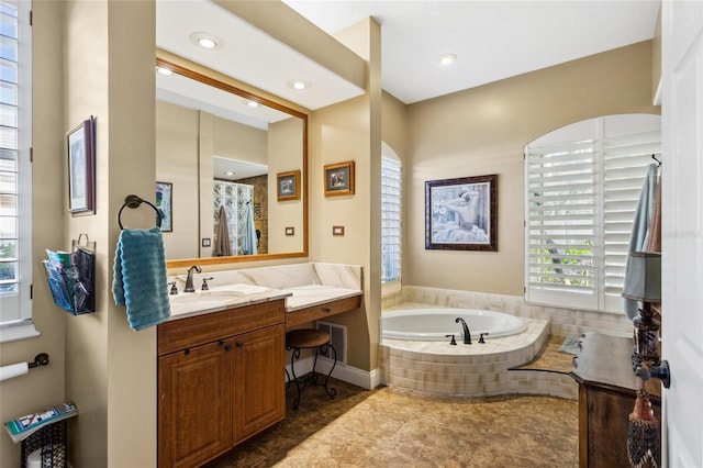 full bath with a bath, recessed lighting, and vanity