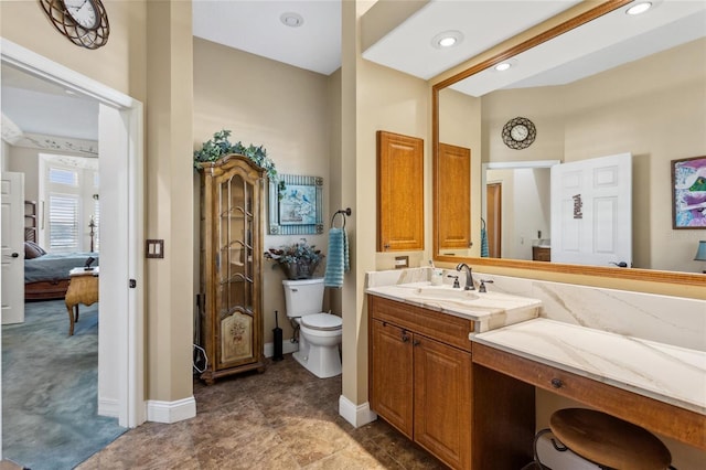 bathroom featuring vanity, baseboards, recessed lighting, ensuite bathroom, and toilet