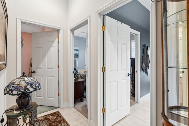 hall featuring light tile patterned floors