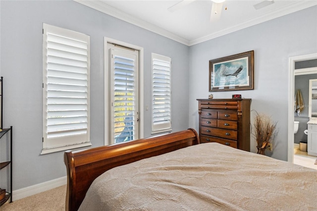 bedroom featuring ensuite bath, carpet, crown molding, baseboards, and ceiling fan