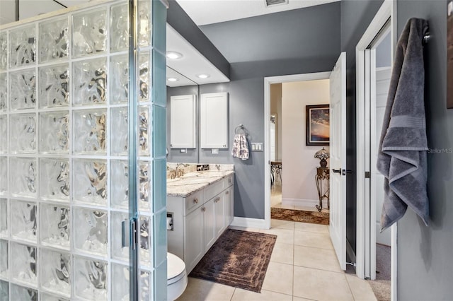 bathroom featuring tile patterned floors, visible vents, baseboards, and vanity