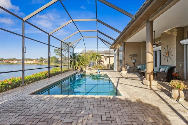 pool featuring ceiling fan, a water view, a lanai, outdoor lounge area, and a patio area