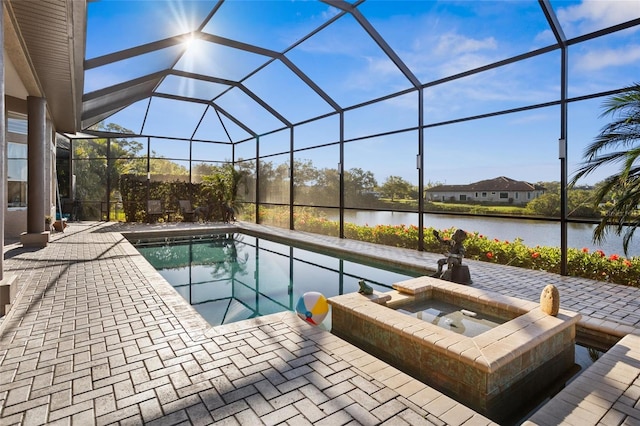 pool featuring glass enclosure, a patio, and a water view