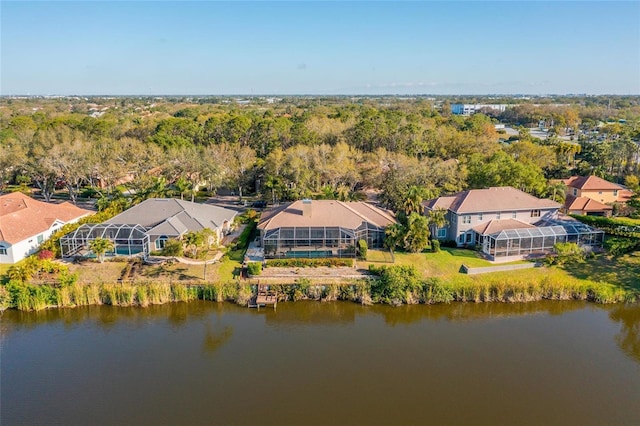 drone / aerial view with a water view and a residential view