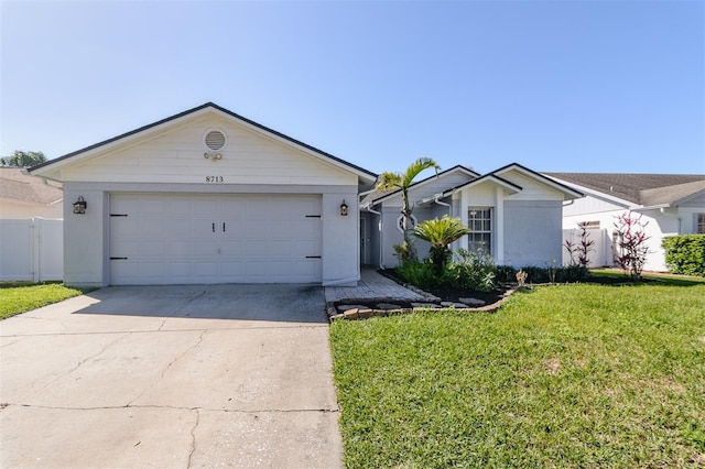 single story home with a garage, concrete driveway, a front yard, and fence