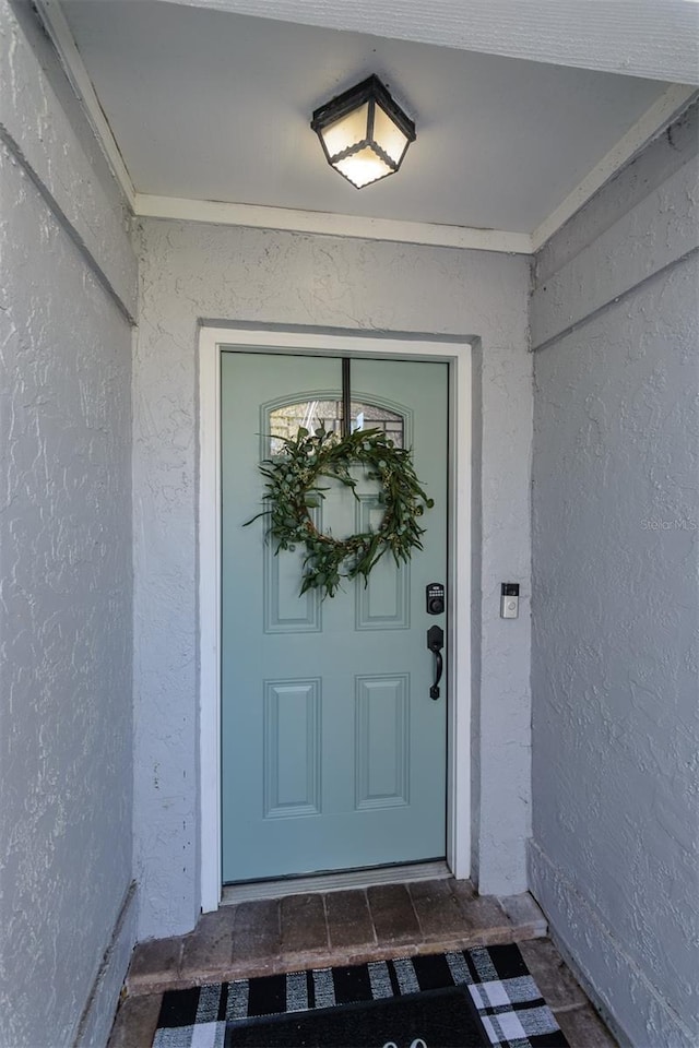 property entrance featuring stucco siding