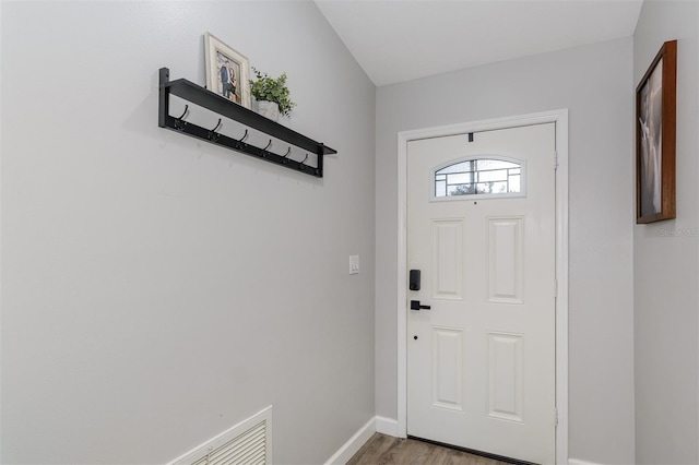 foyer entrance with baseboards and light wood finished floors