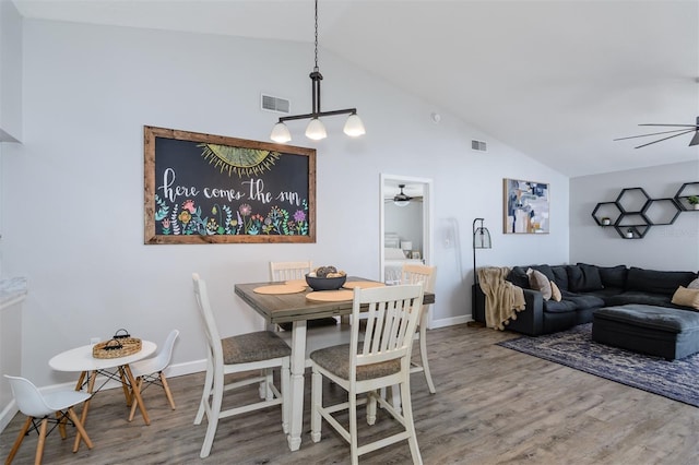 dining room with wood finished floors, a ceiling fan, visible vents, and baseboards